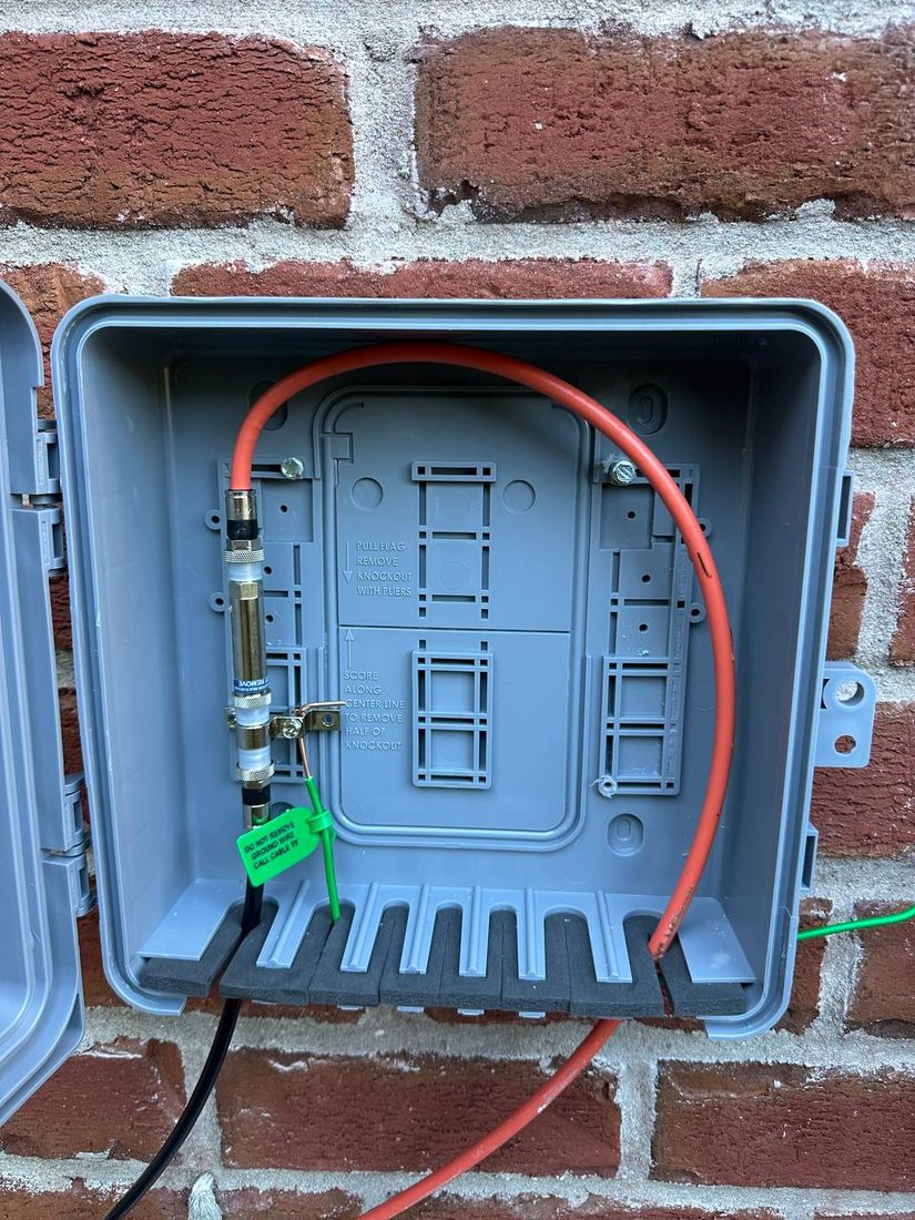 Grounded demarcation enclosure on a brick wall